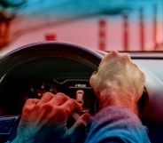 stock image of person driving with trans pride colours