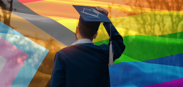 Student graduating in front of a pride flag