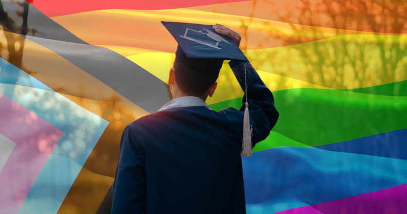 Student graduating in front of a pride flag