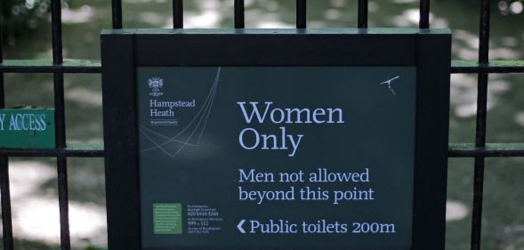 The sign indicating the 'Women Only' swimming pool is seen attached to gates on Hampstead Heath in central London