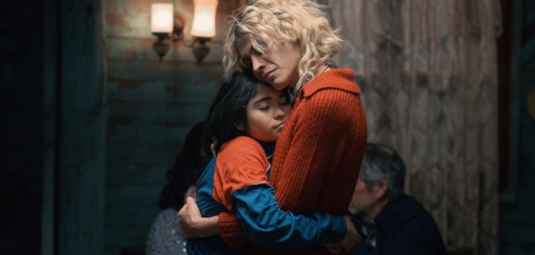 The Mysterious Gaze of the Flamingo still: a child hugging an adult