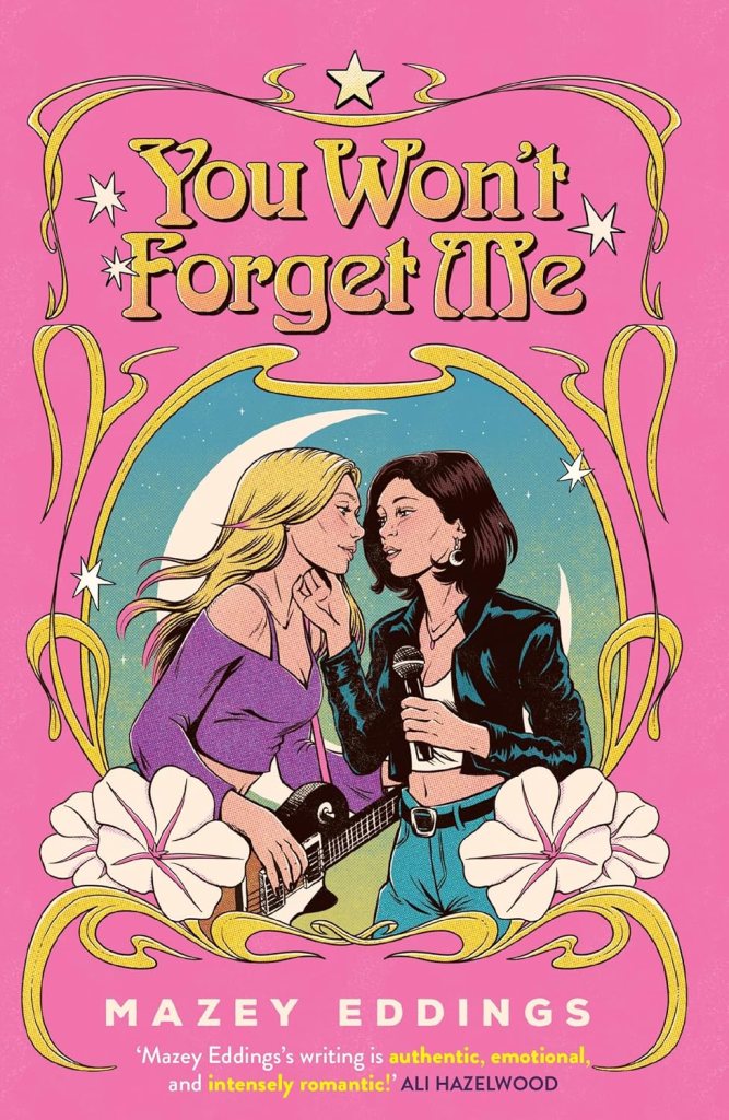 You Won’t Forget Me by Mazey Eddings cover: two women, one with a guitar and the other with a mic, singing close together with a pink and gold floral book outline