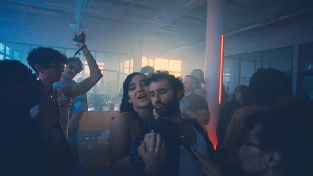 Club Kid still: twoo people dancing in a smokey club room