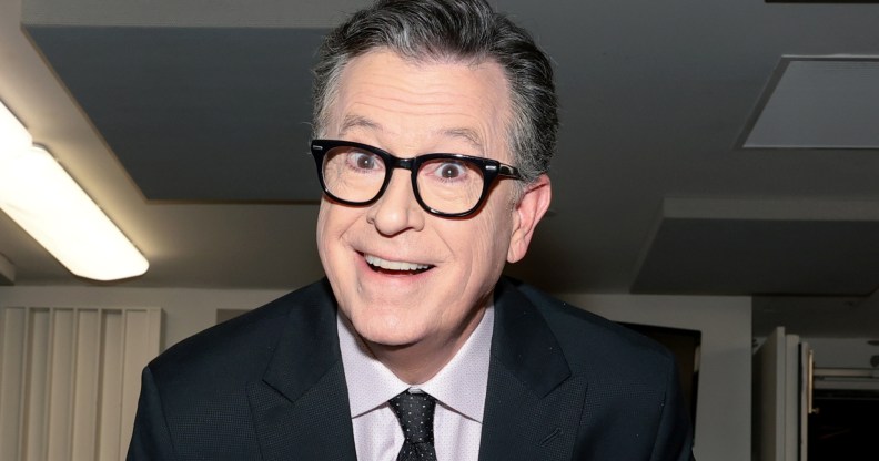Stephen Colbert smiling at the camera in a suit