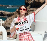 Emily in Paris star Lily Collins posing in Greece with a filming clapper board