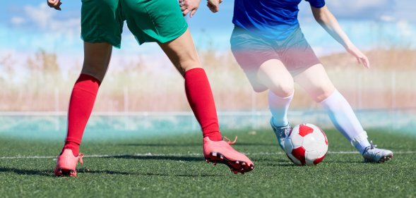 two footballers with trans pride colours