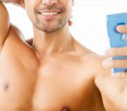shirtless man using phone