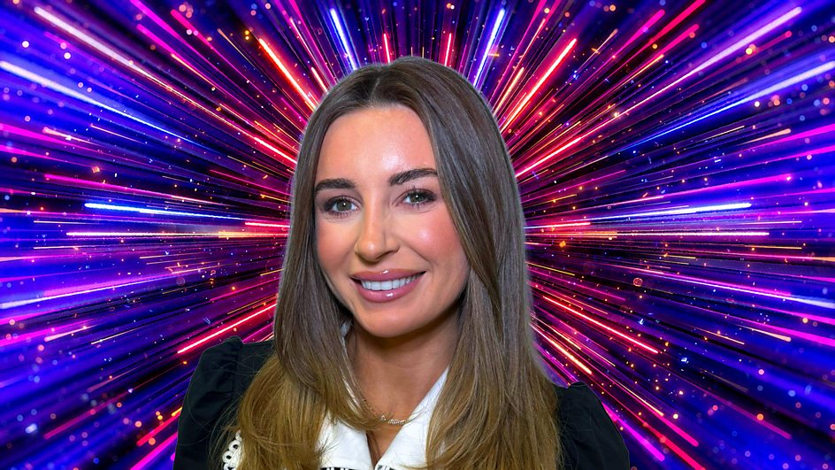 Dani Dyer in front of a colourful firework explosion