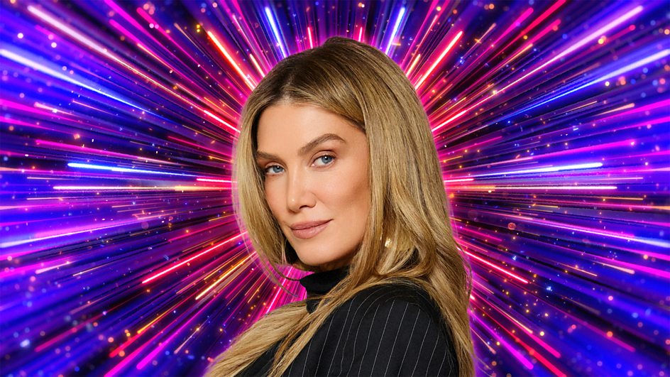 Delta Goodrem in front of a colourful firework explosion