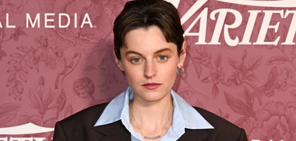 Emma Corrin at Variety 2026 Power of Women London. They're wearing a pale blue shirt under a brown suit