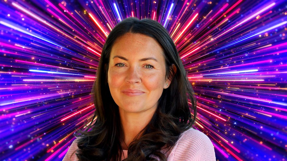 Lacey Turner in front of a colourful firework explosion