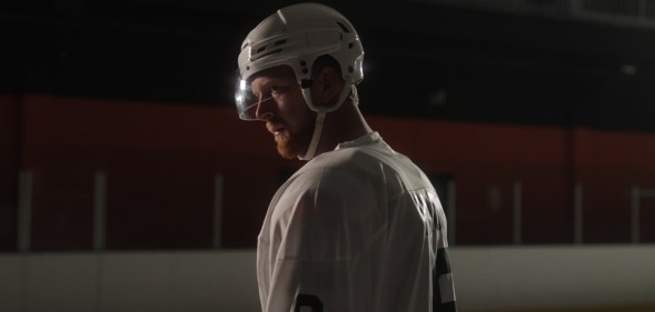 Luke Prokop in ice hockey gear in a dim rink