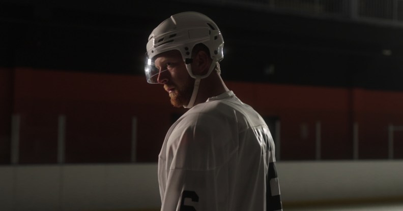 Luke Prokop in ice hockey gear in a dim rink