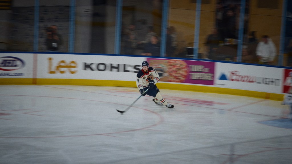 The Hockey Player still: Luke Prokop skating on a blurry rink