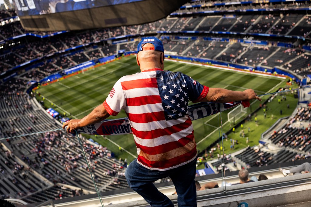 A USA fan wears a t-shirt with the US flag as he attends the 2026 World Cup football match
