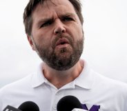JD Vance, pictured speaking into a set of microphones.