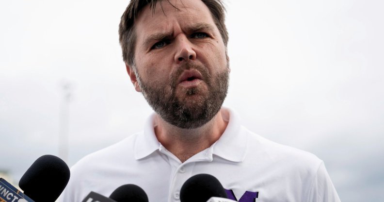 JD Vance, pictured speaking into a set of microphones.