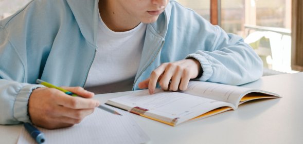 a teen using a revision guide