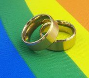 wedding rings on pride flag