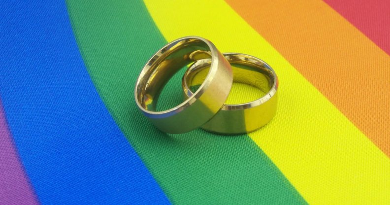 wedding rings on pride flag