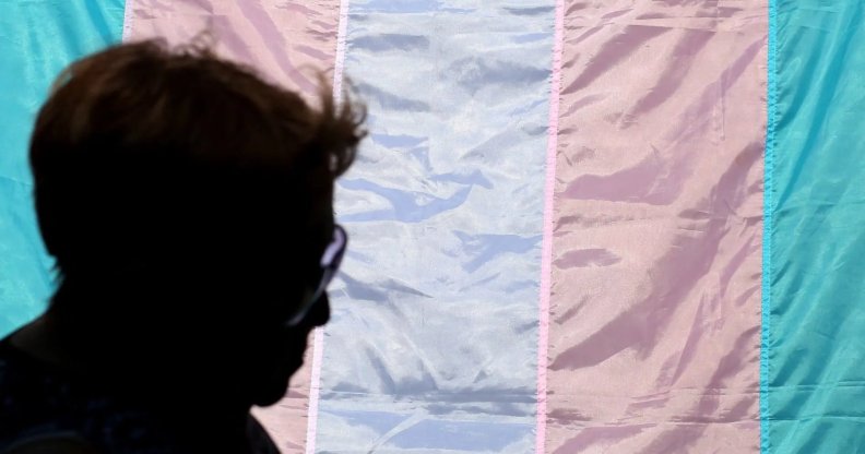 person with trans flag