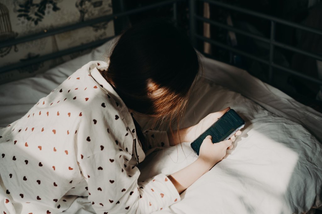 Portrait of a person with mobile phone in hand