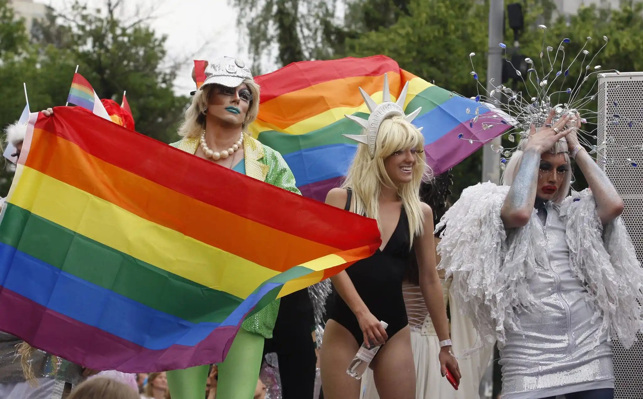 Pride-goers waving rainbow flags in Kyiv