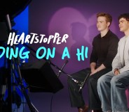 Heartstopper: Ending on a Hi still: Kit Connor and Joe Locke sat on set