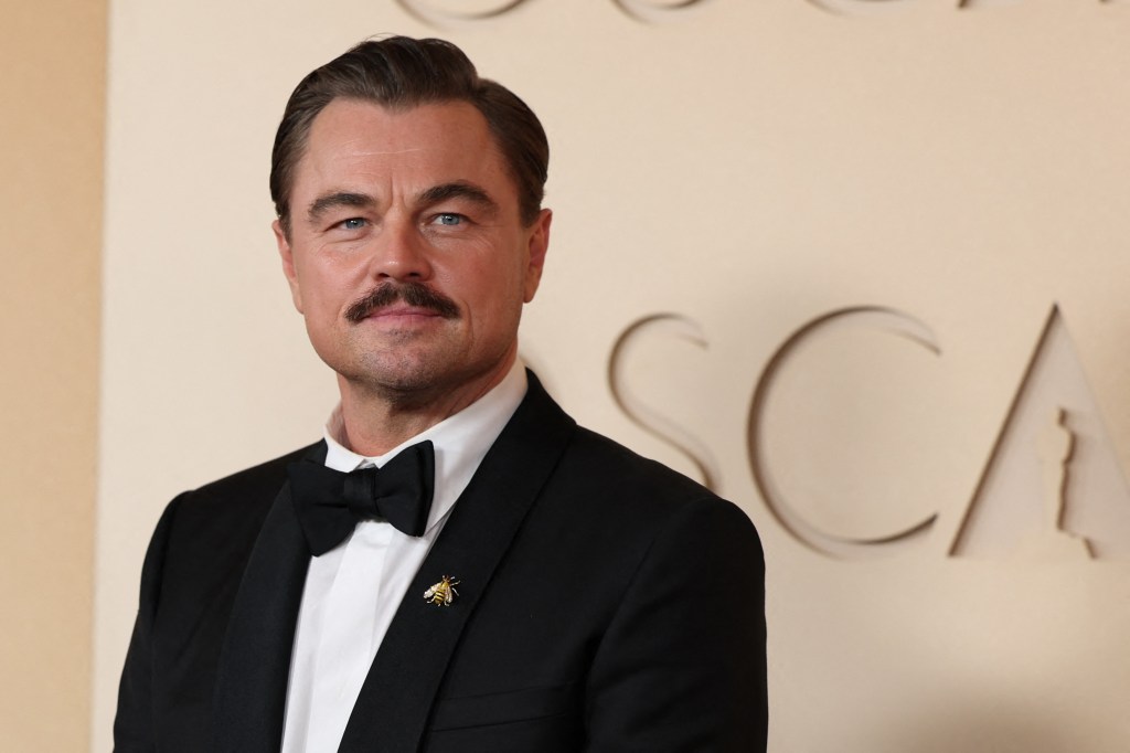 Leonardo DiCaprio in a suit with a bee pin