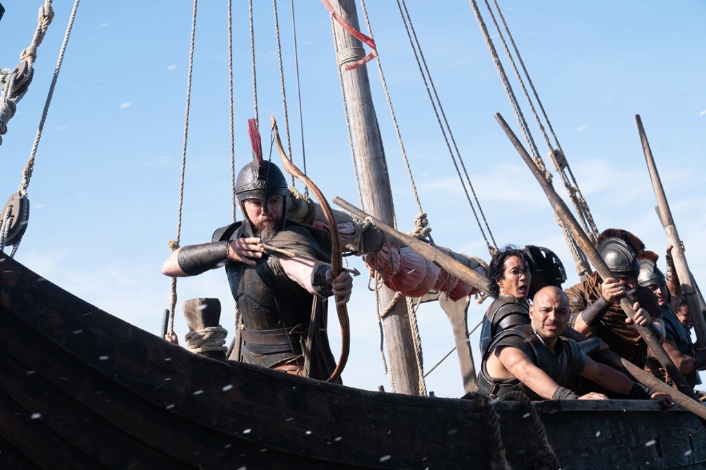 The Odyssey still: Matt Damon shooting a bow and arrow from a ship
