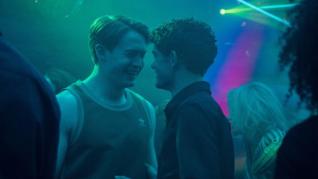 Heartstopper still: Kit Connor and Joe Locke on set in a club