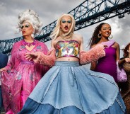 Smoggie Queens still, five individuals walking against a grey cloudy sky