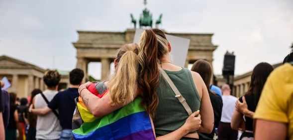 People gather at the Brandenburg Gate in a memorial of the Berlin pride attack