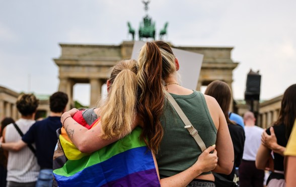 People gather at the Brandenburg Gate in a memorial of the Berlin pride attack