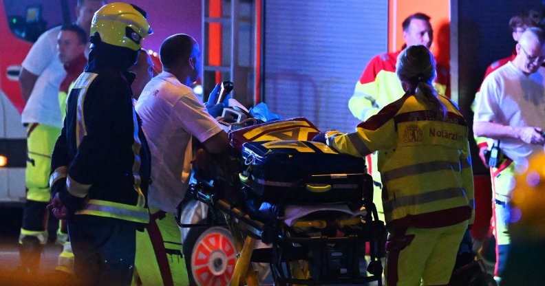 Emergency personnel and police work near the scene where one person was killed and around 15 injured after a car is believed to have hit the crowd on the outskirts of the Christopher Street Day (CSD)