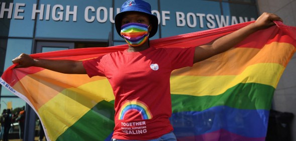 Activists carry a rainbow flag outside the Botswana High Court on October 12, 2021