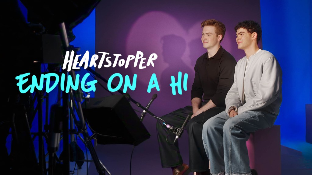 Heartstopper: Ending on a Hi still: Kit Connor and Joe Locke sat on set