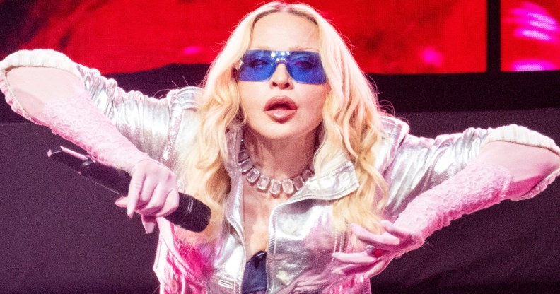 Madonna's Confessions II is out now. Madonna performing on stage in silver jacket and blue glasses