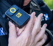 A police man putting on a bodycam