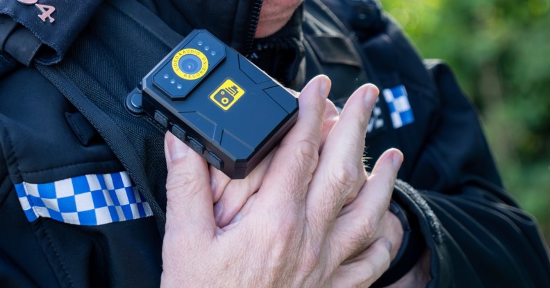 A police man putting on a bodycam