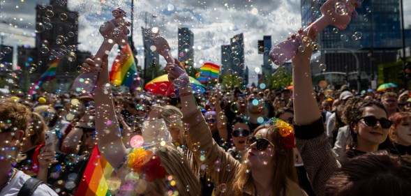 Participants blow soap bubbles as they celebrate at the Warsaw Pride parade in 2026