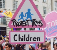 A participant holds a 'Protect Trans Children' placard during London Trans Pride 2025