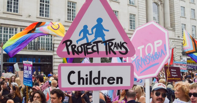 A participant holds a 'Protect Trans Children' placard during London Trans Pride 2025