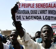 A man holds a sign reading 'No to LGBT agenda' during a protest