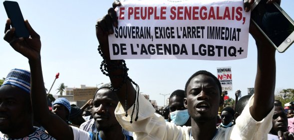 A man holds a sign reading 'No to LGBT agenda' during a protest