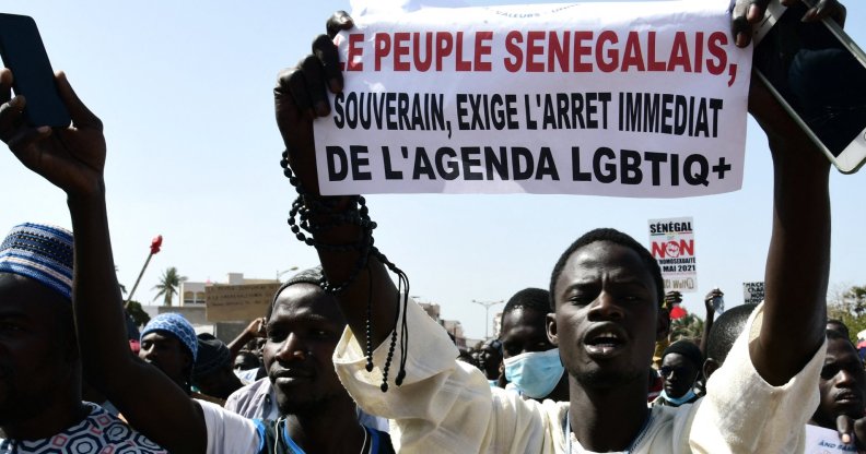 A man holds a sign reading 'No to LGBT agenda' during a protest