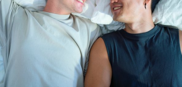 two men in bed