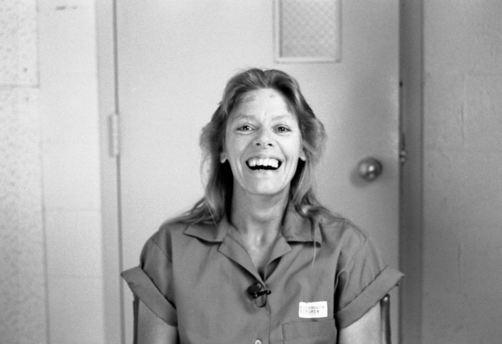 Aileen: Queen of the Serial Killers documentary still of Aileen Wuornos. Balck and white, she's smiling