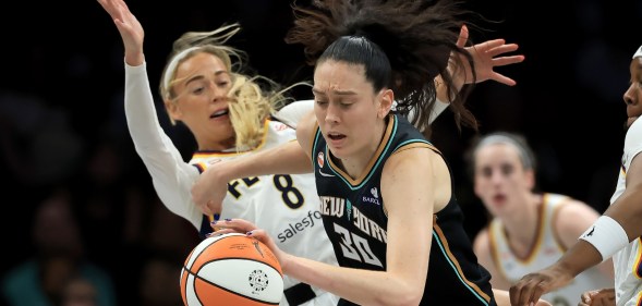 Sophie Cunningham #8 of the Indiana Fever is called for a foul as she collides with Breanna Stewart #30 of the New York Liberty