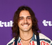 Charlie Gillespie smiling against a purple background